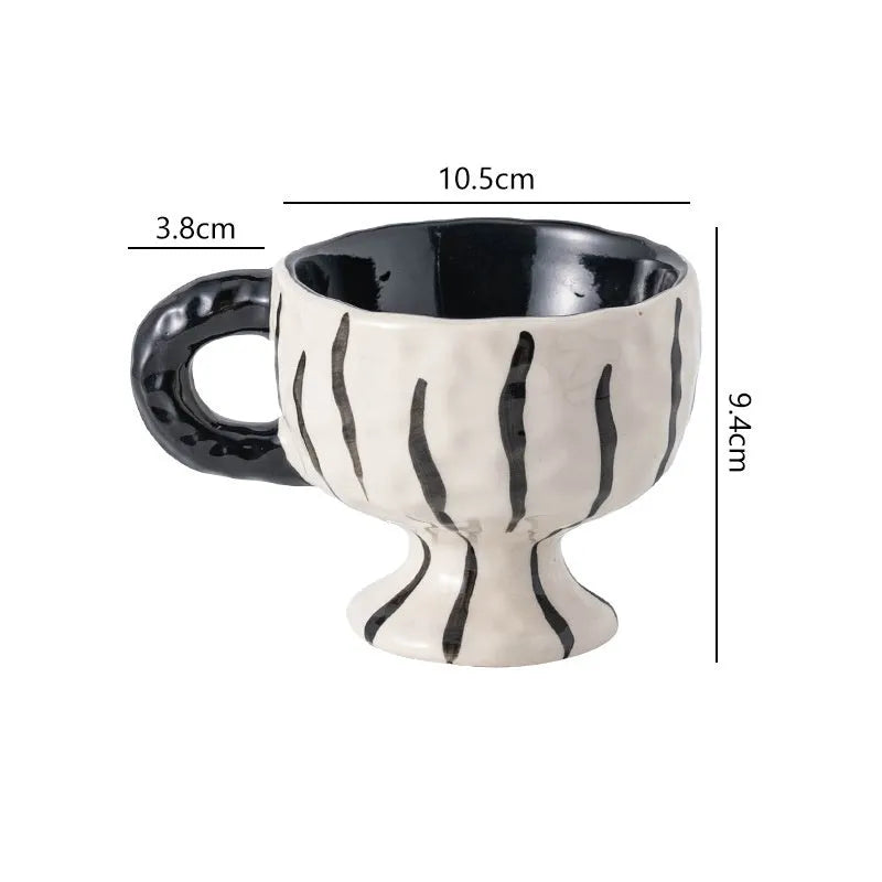 Hand-pinched irregular ceramic mug in a solid colour, shown from the side.