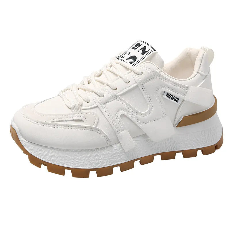 Black and white low-top lace-up sneakers with round toe and rubber sole