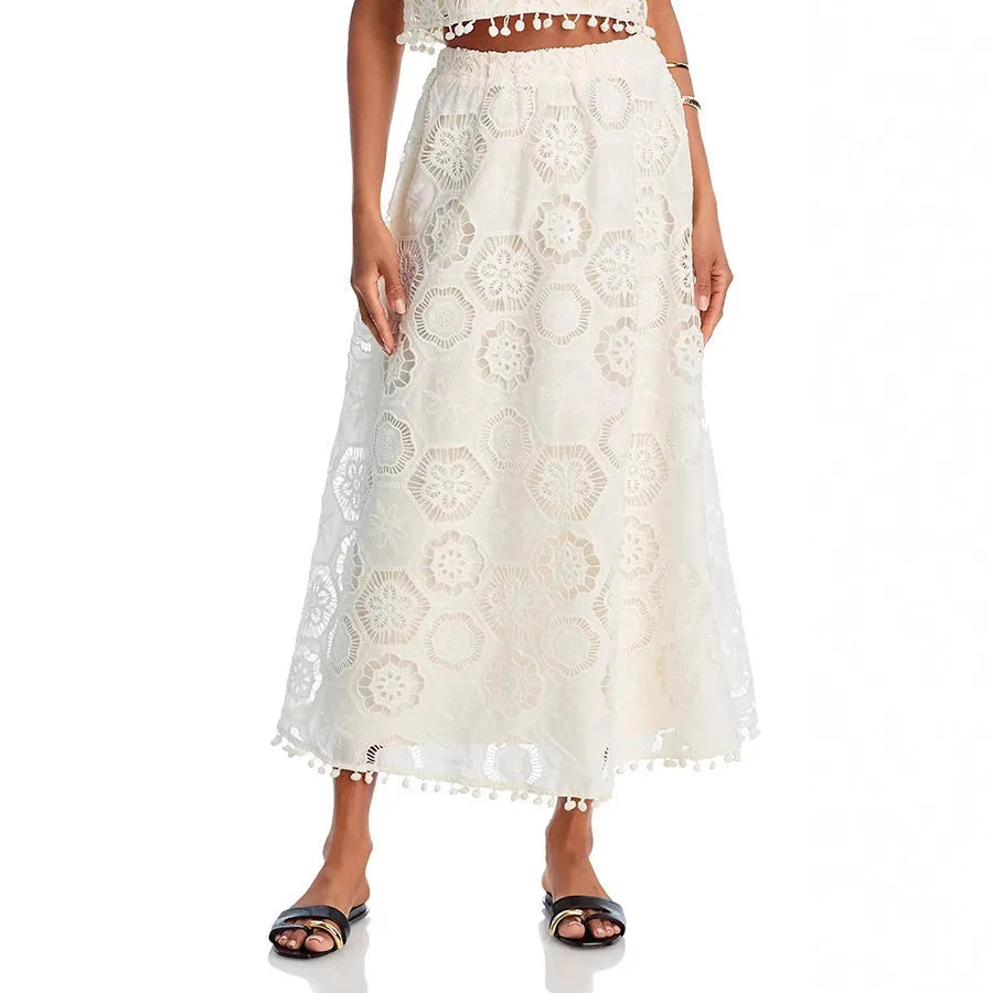 White women's retro style polyester suit with sleeveless top and embroidered long skirt.
