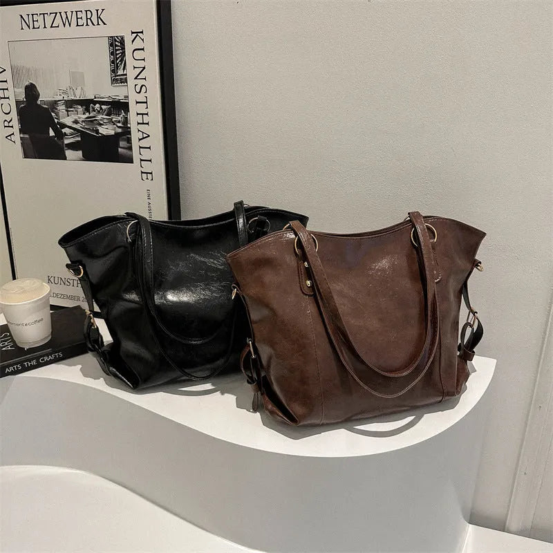 New retro commuter tote bag in soft PU, black colour, bucket shape with visible stitching and double shoulder straps