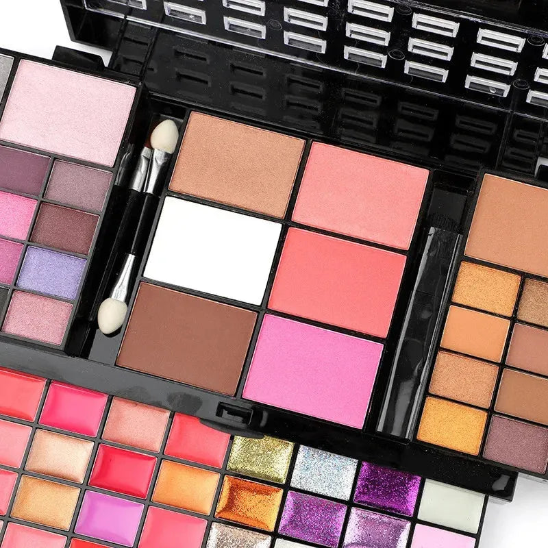 74 colour makeup palette set open showing four layers of eyeshadows, lip glosses, blushes, and contour powders with brushes