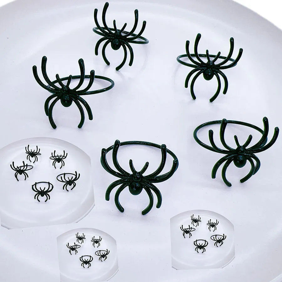 Six black spider-shaped alloy metal napkin rings for Halloween table decoration