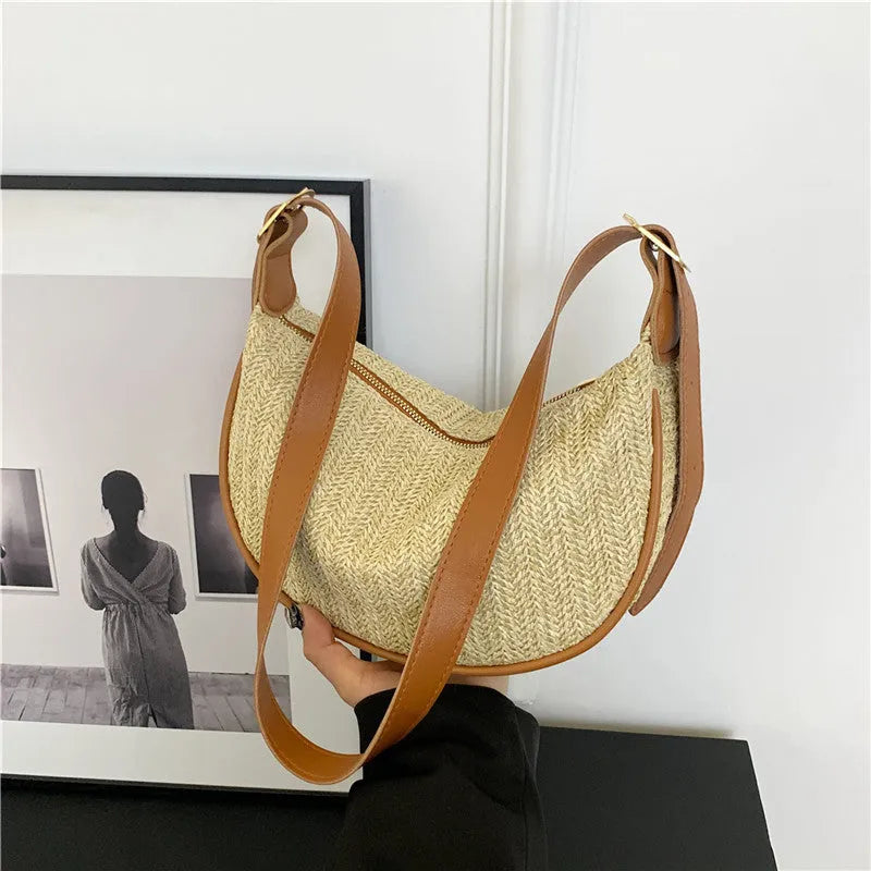 Women's knitted straw woven crossbody bag showing internal phone and file compartments