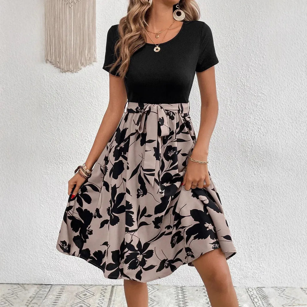 Women's khaki A-line casual dress with shoulder strap detail on a hanger.