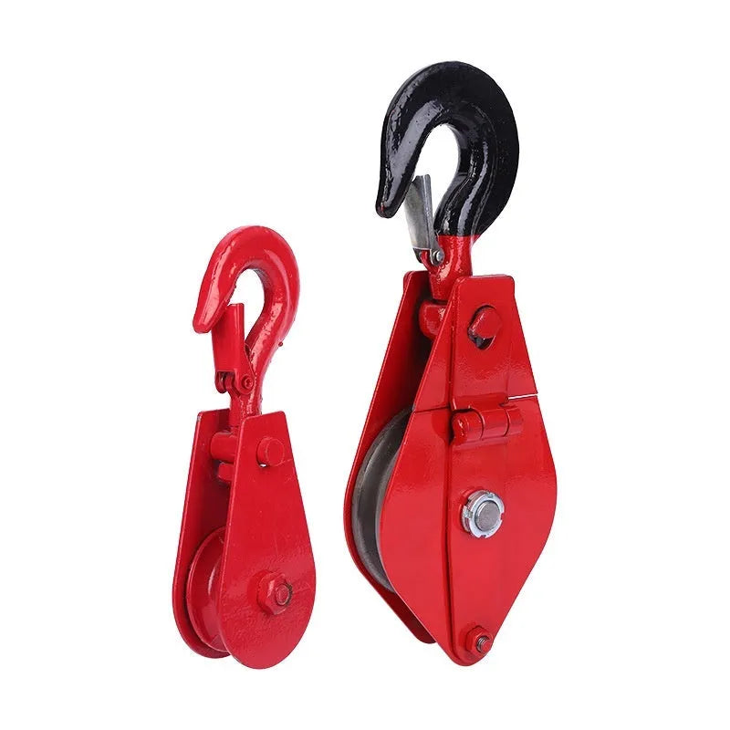 Red industrial single sheave lifting pulley with a forged steel hook and safety latch.