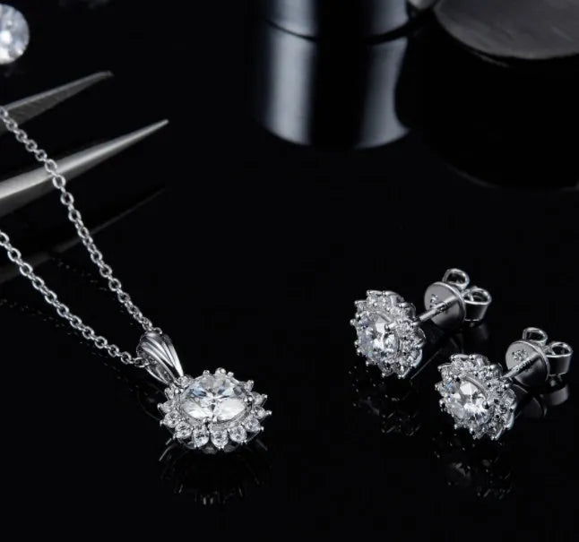 925 silver three piece jewellery set with moissanite pendant, stud earrings, and bracelet on white background
