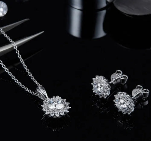925 silver three piece jewellery set with moissanite pendant, stud earrings, and bracelet on white background