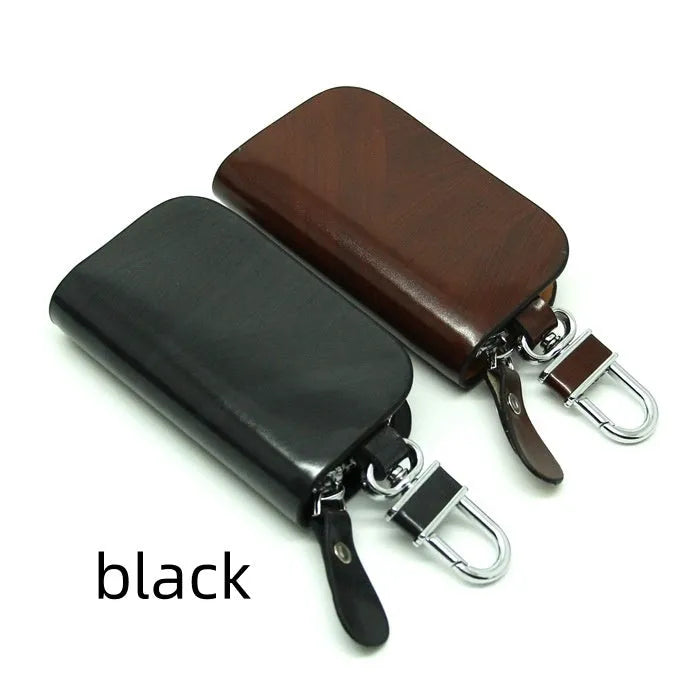 Black genuine leather car key case with a silver V-shaped zipper closed.