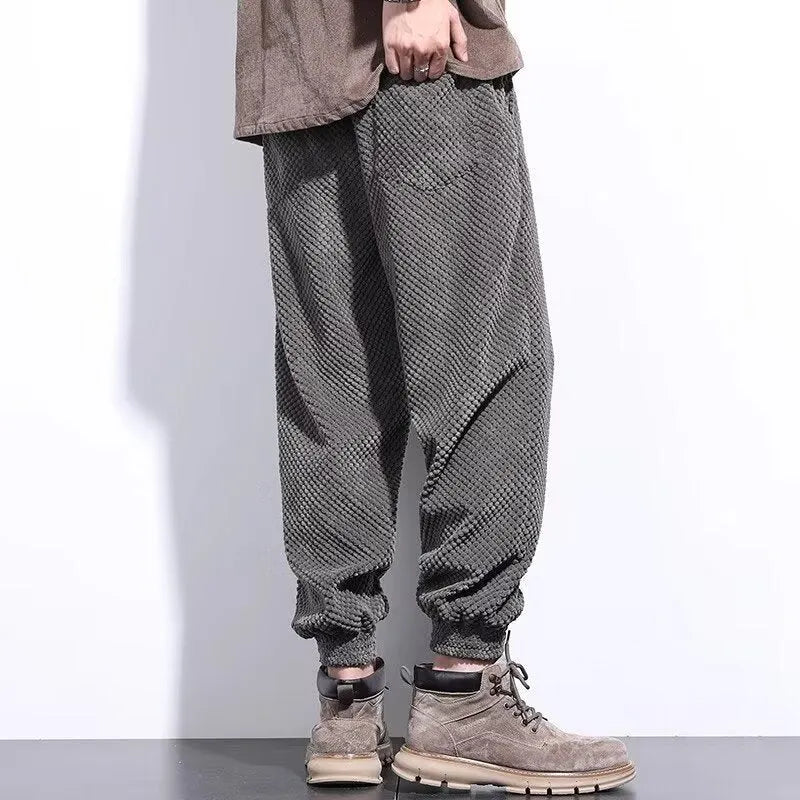 Men's grey ankle-tied straight leg casual sweatpants laid flat