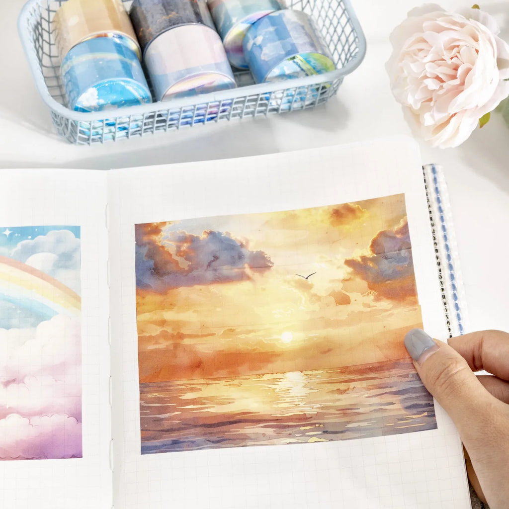 Roll of Japanese paper decorative tape with sky theme designs including clouds and nebula patterns