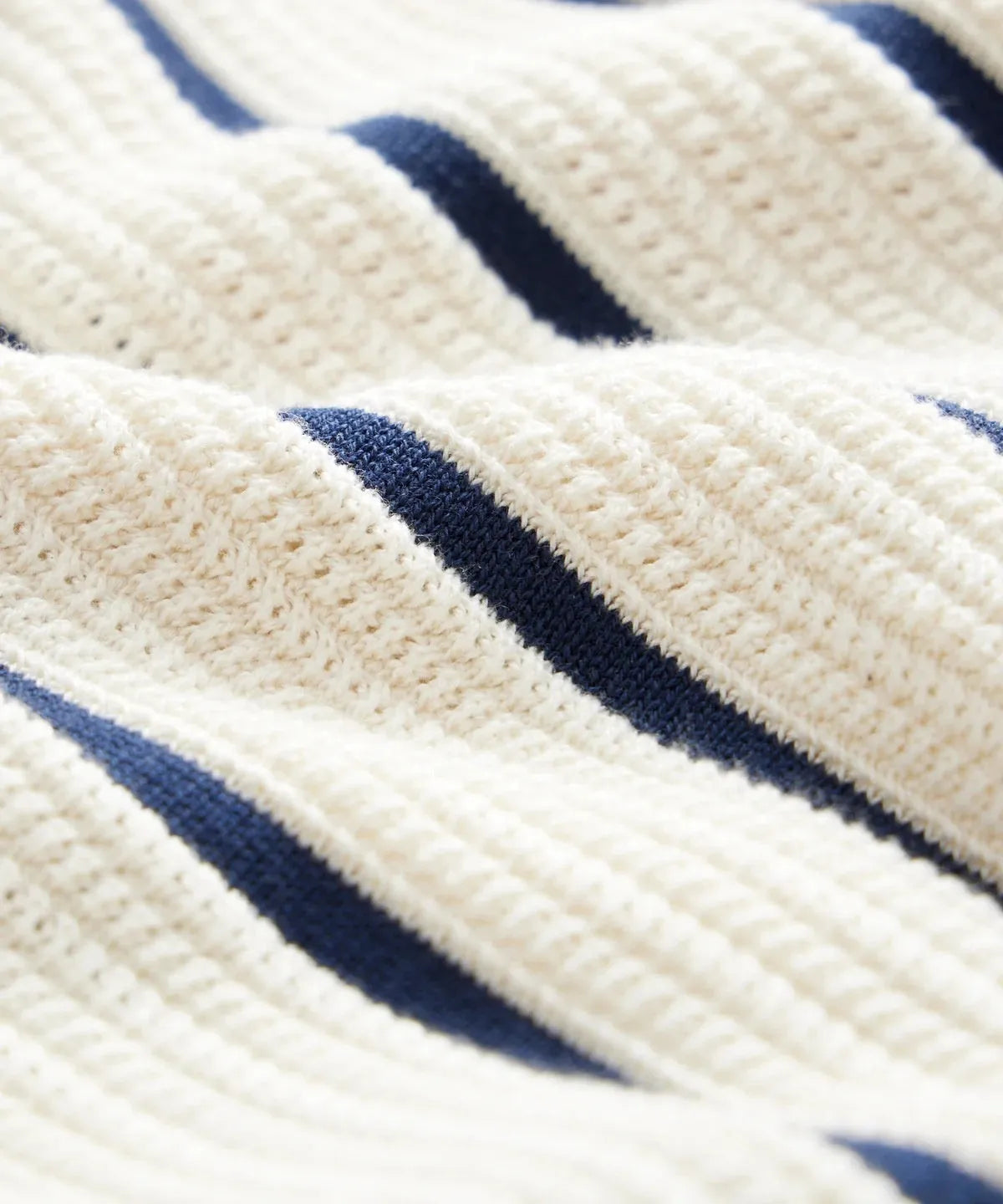 Men's white asymmetric lapel knitted short sleeve top laid flat.