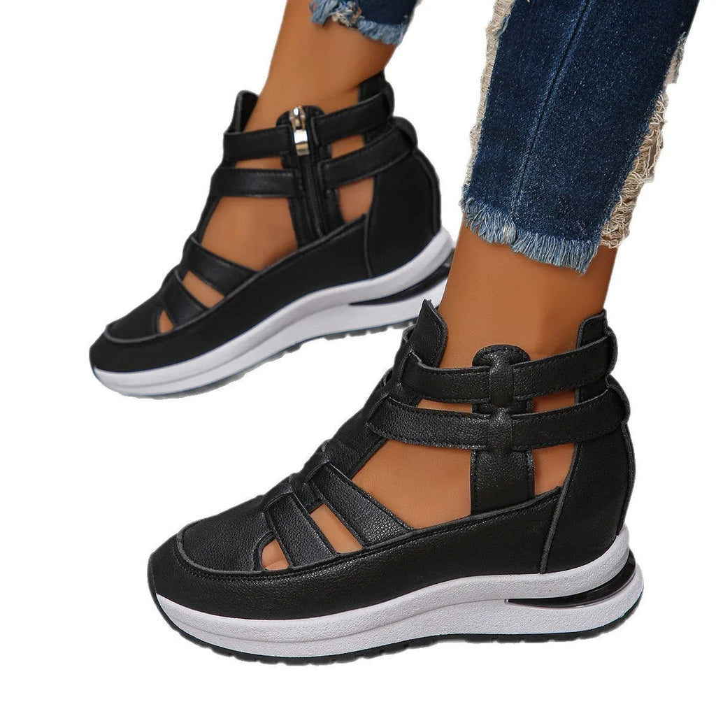 Women's black close-toed sandals with hollow-out patterning and platform sole, showing Velcro fastening