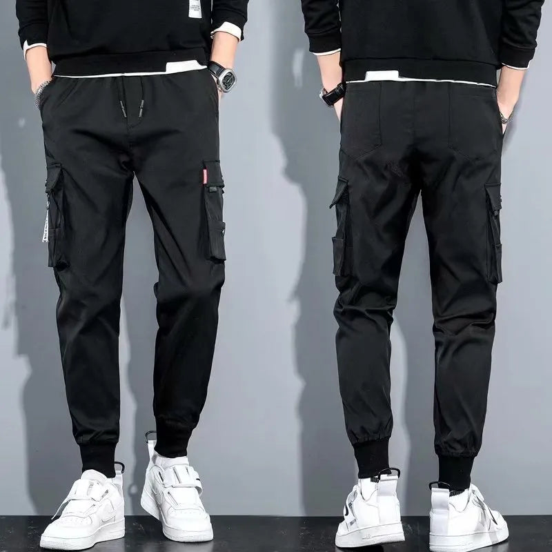 Men's cotton-polyester sports overalls in black with embossed finish and printed details, side view
