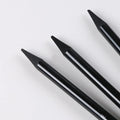 Set of six graphite pencils and three carbonized drawing pencils with wooden casings on a blister card.
