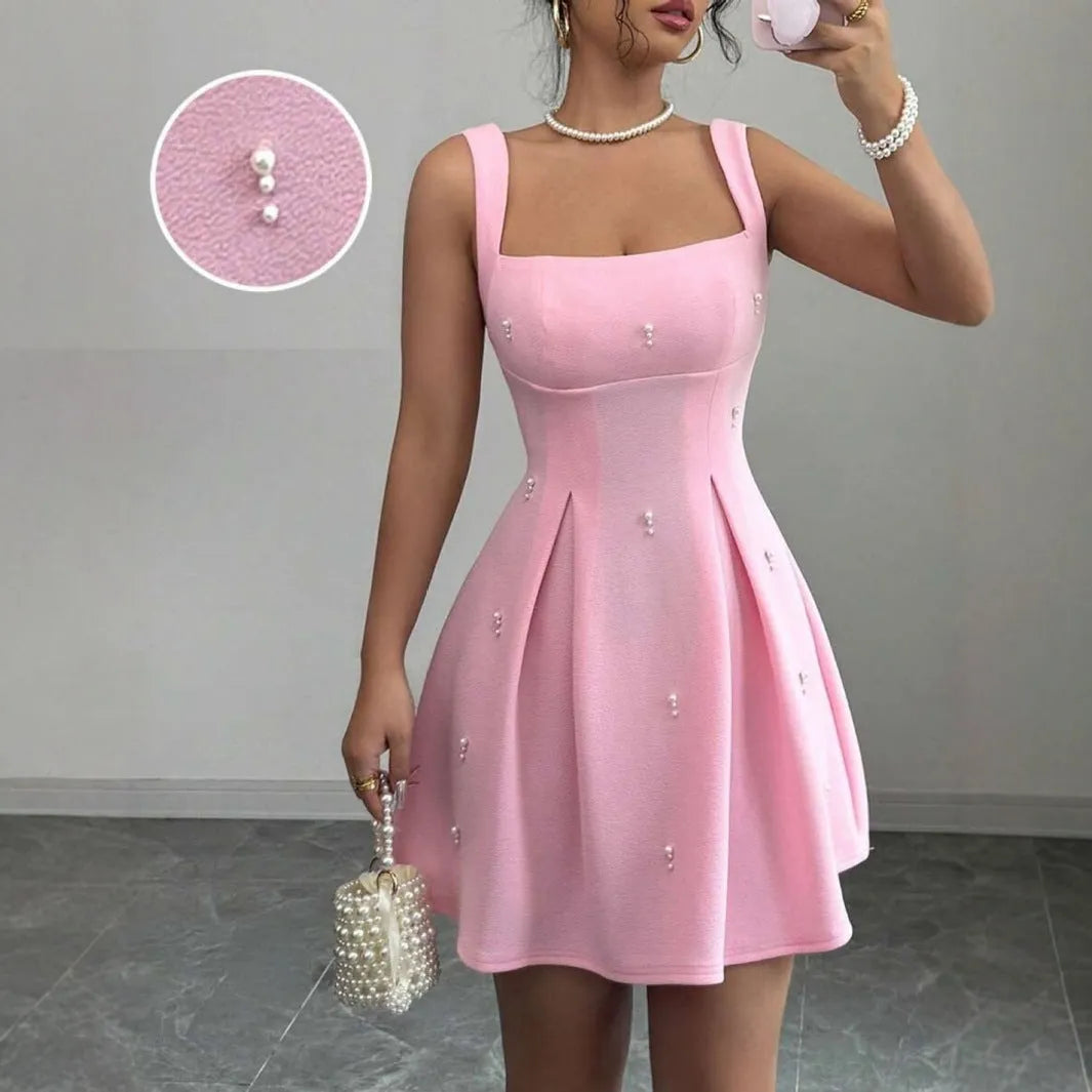 Pink high-waist A-line suspenders dress with short sleeveless skirt in polyester, shown on a model