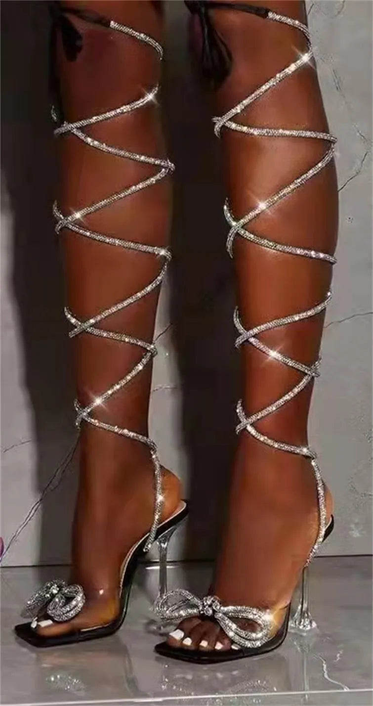 Plus size women's black strappy sandals with rhinestone decoration and a square toe on a rubber sole.