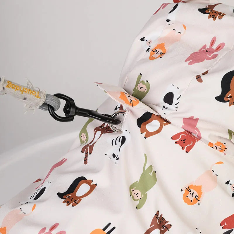 Beige dog raincoat with cartoon small animal print, showing PU waterproof material