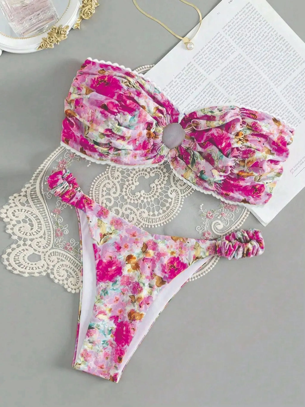 A colourful floral print lace tube top bikini set with matching shorts on a mannequin.