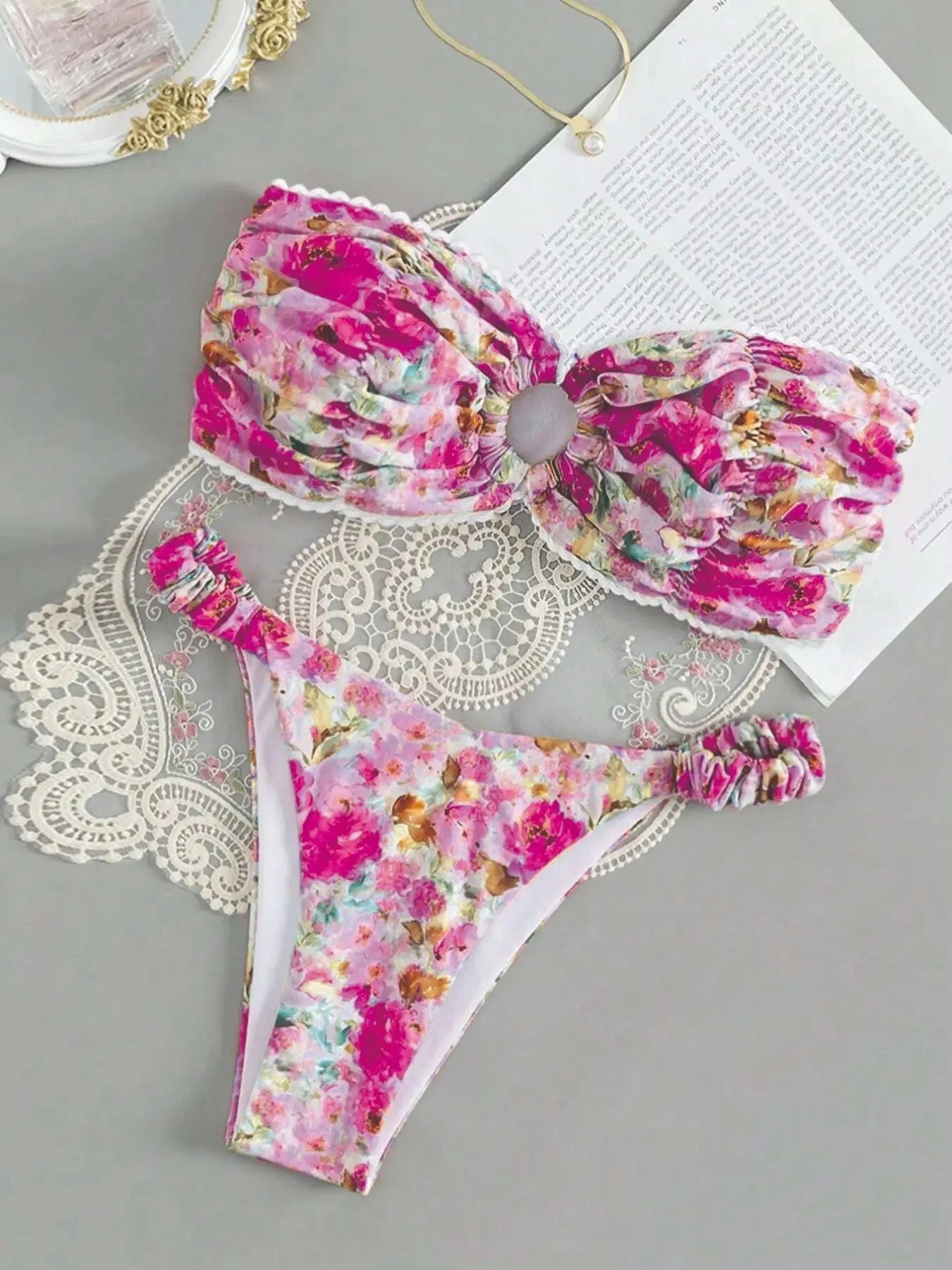 A colourful floral print lace tube top bikini set with matching shorts on a mannequin.