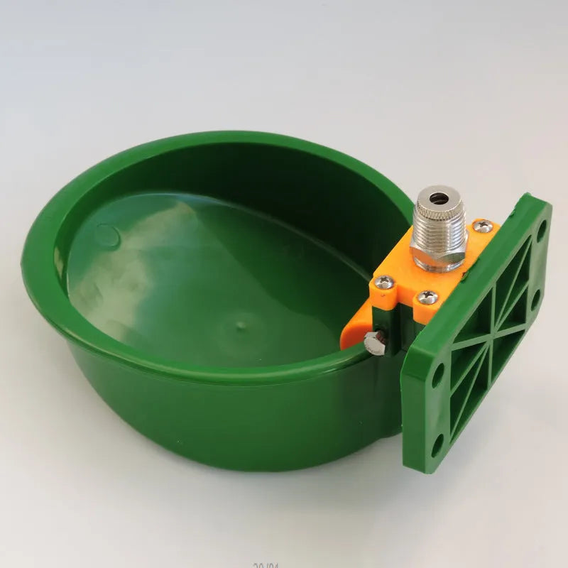Green plastic livestock drinking bowl for sheep and pigs on farm
