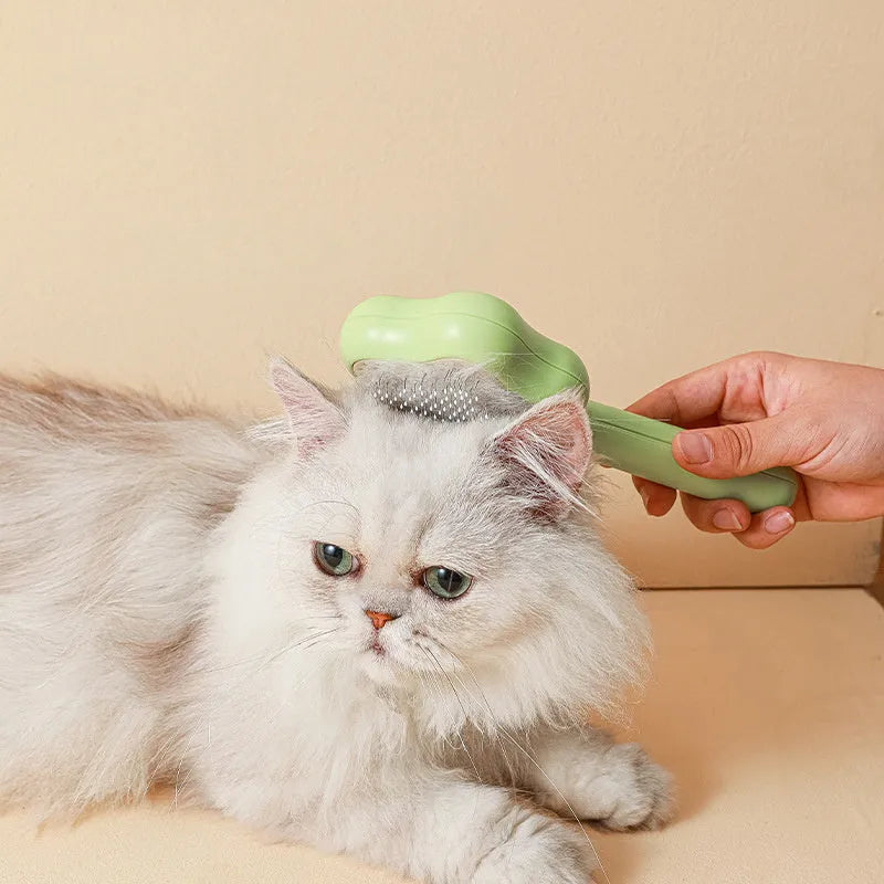 Self-cleaning stainless steel needle cat comb with magic wand handle in green or yellow