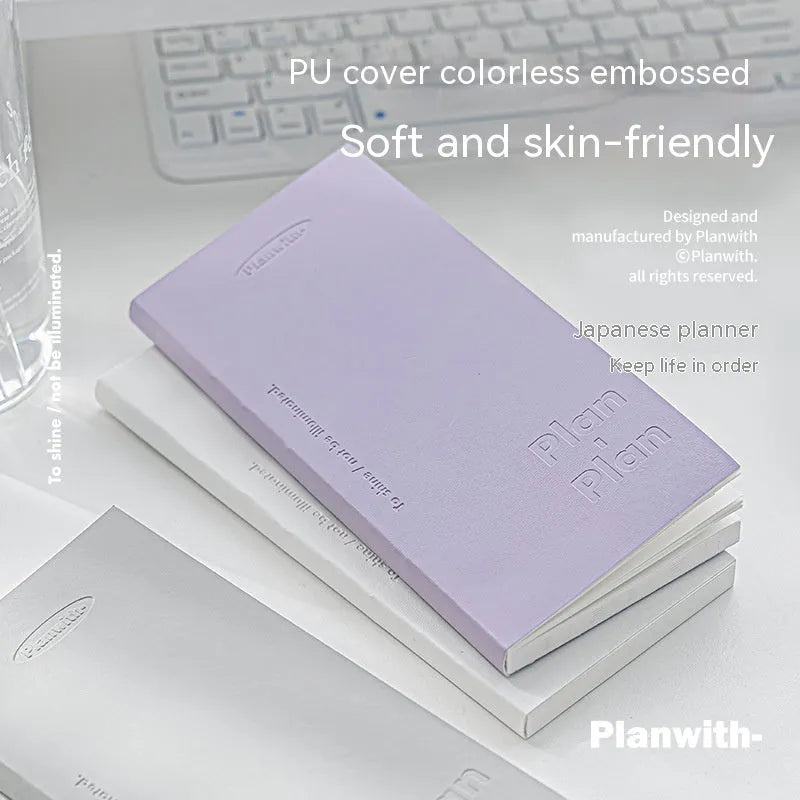 Embossed simple visual daily meter notebook in blue, showing its cover and page layout.