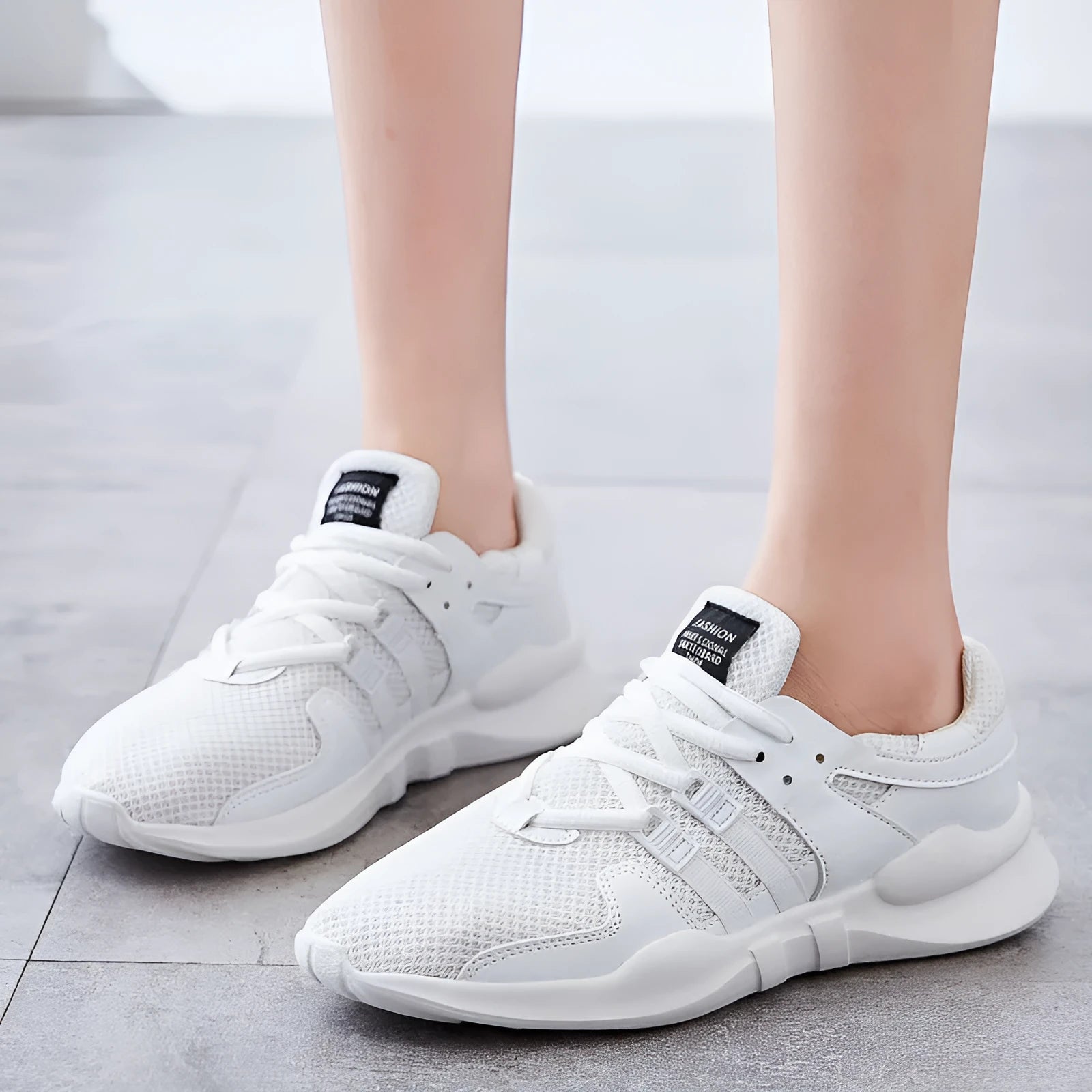 Breathable hollow-out mesh sneakers in black on a white background.