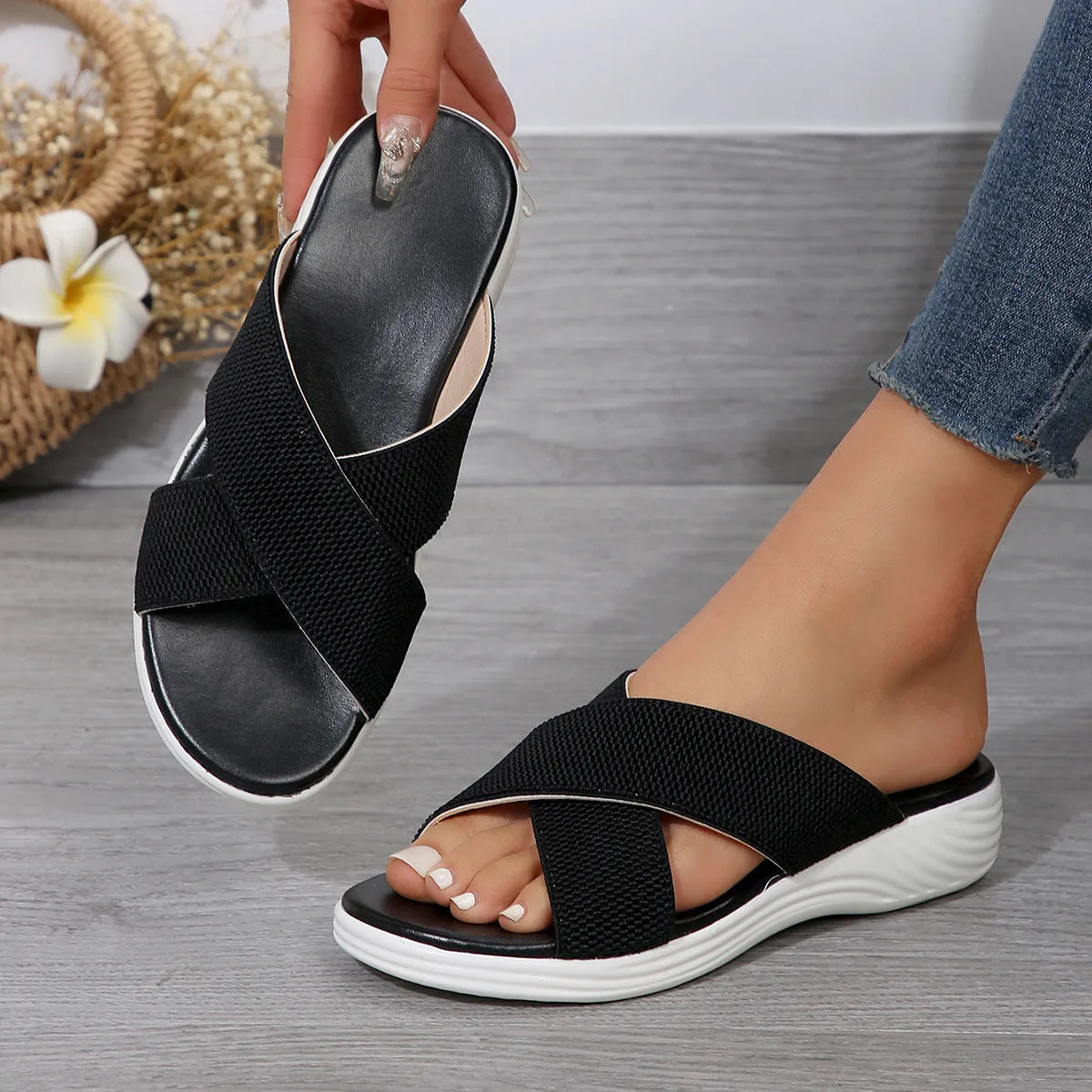 Black women's wedge peep-toe summer slippers with cross straps and a thick rubber sole.