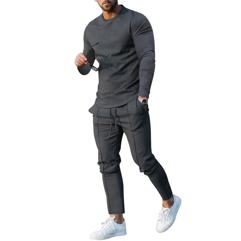 Men's light grey polyester two-piece suit with long sleeve t-shirt and trousers on a hanger.