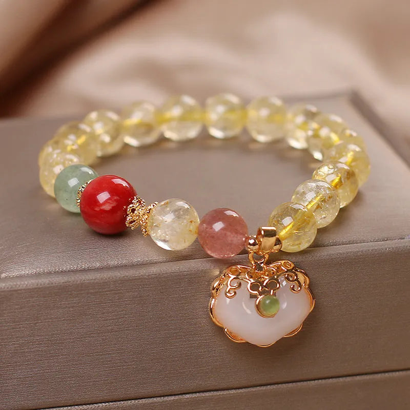 Women's bracelet with a citrine jade ruyi pendant and yellow hair crystal on an alloy band.
