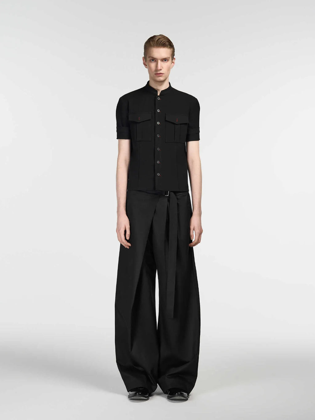 Black straight-leg trousers with a single pleat and adjustable waistband on a neutral background.