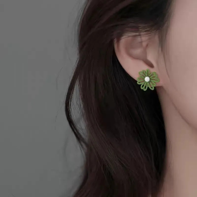 A pair of alloy cartoon flower stud earrings in blue and orange two-tone colours.