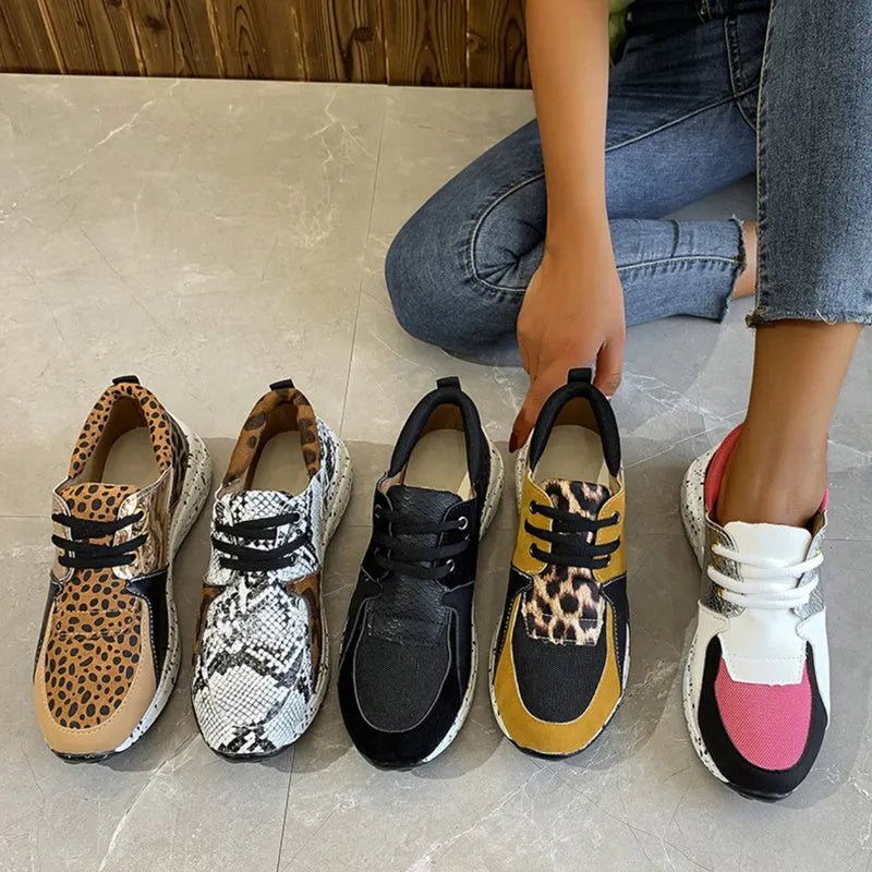 Women's black suede casual sneakers with a wedge heel and round toe on a white background.