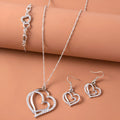 Silver romantic crystal heart jewelry set with bracelet necklace earrings on white background