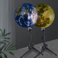 Star projector night light showing earth projection, with flexible hose bracket and USB cable.