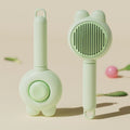Green self-cleaning pet grooming brush with stainless steel teeth and rubber tips