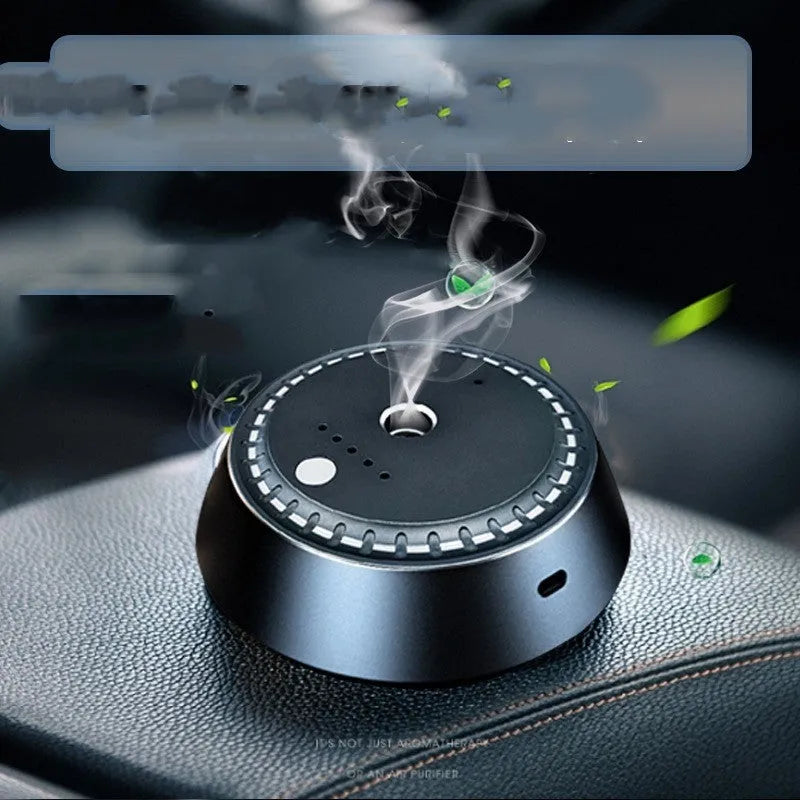 Black metal smart car aroma diffuser with USB cable, showing compact 9cm by 4.5cm size.