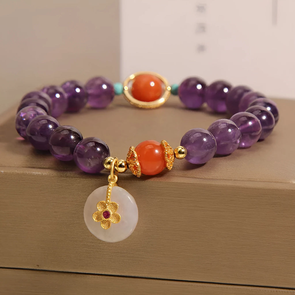 Natural amethyst bracelet with sliding knot and small flower inlay on a white background