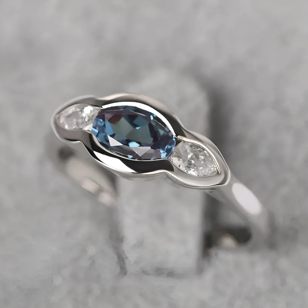 Women's geometric ellipse ring with inlaid zircon stones in white gold finish showing angular design details
