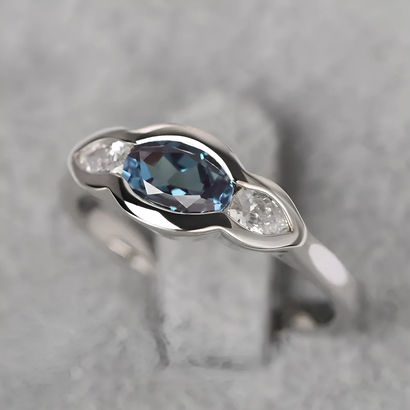 Women's geometric ellipse ring with inlaid zircon stones in white gold finish showing angular design details