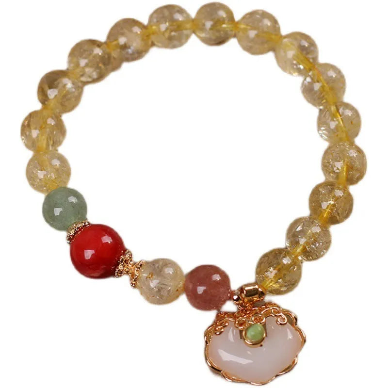 Women's bracelet with a citrine jade ruyi pendant and yellow hair crystal on an alloy band.
