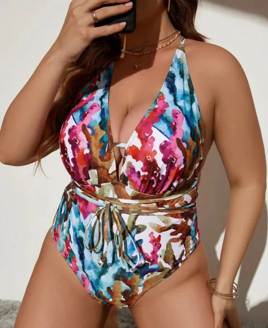 A purple one-piece halter swimsuit for women on a hanger.