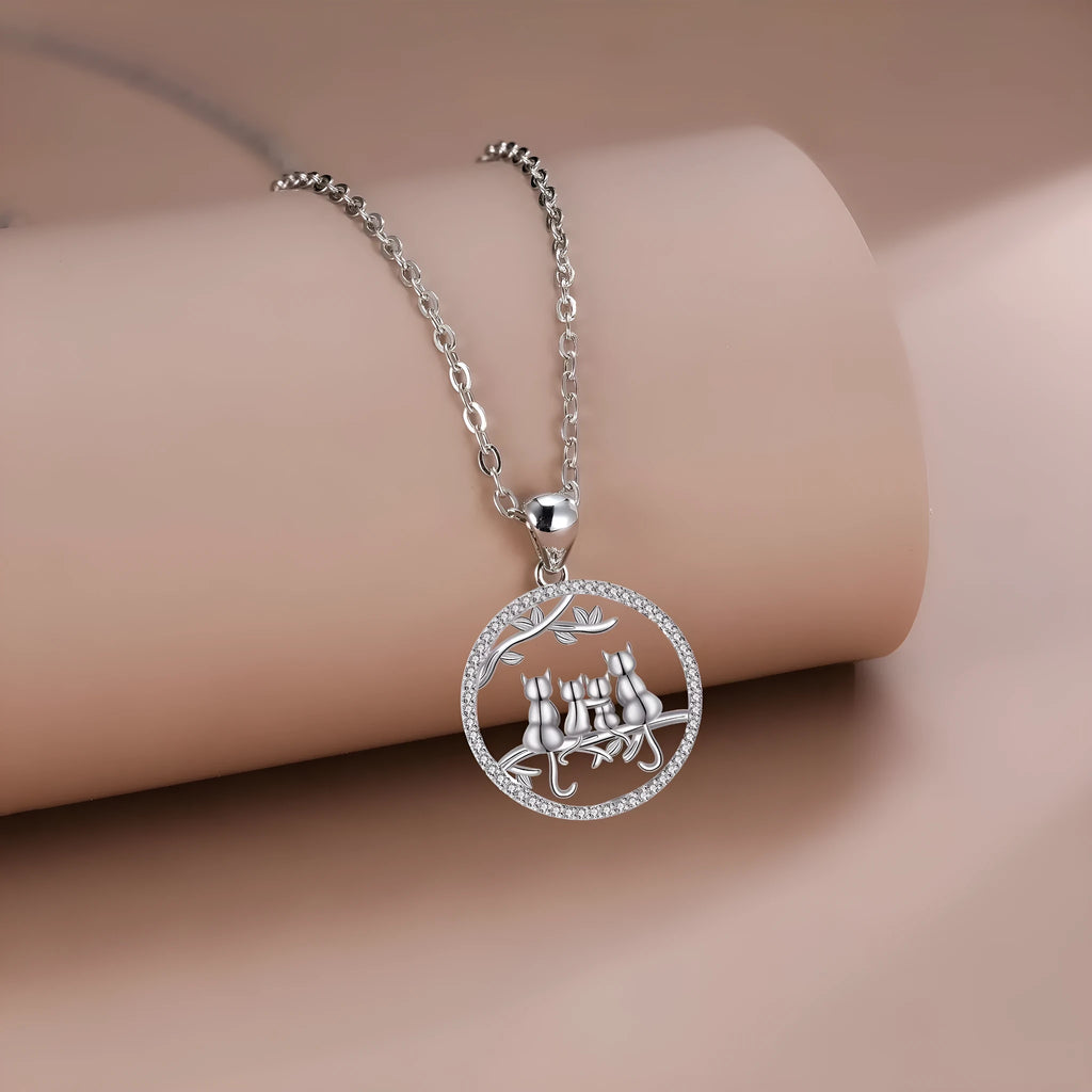 Four kitten pendant necklace on a copper cross chain with electroplated finish.