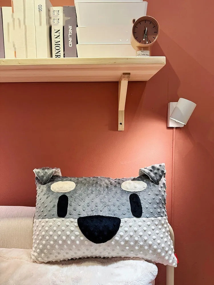 Grey and white decorative dog pillow with Schnauzer print on a sofa