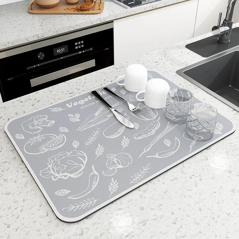 Square diatomite kitchen draining mat in camellia purple on a kitchen worktop, with a teacup resting on it