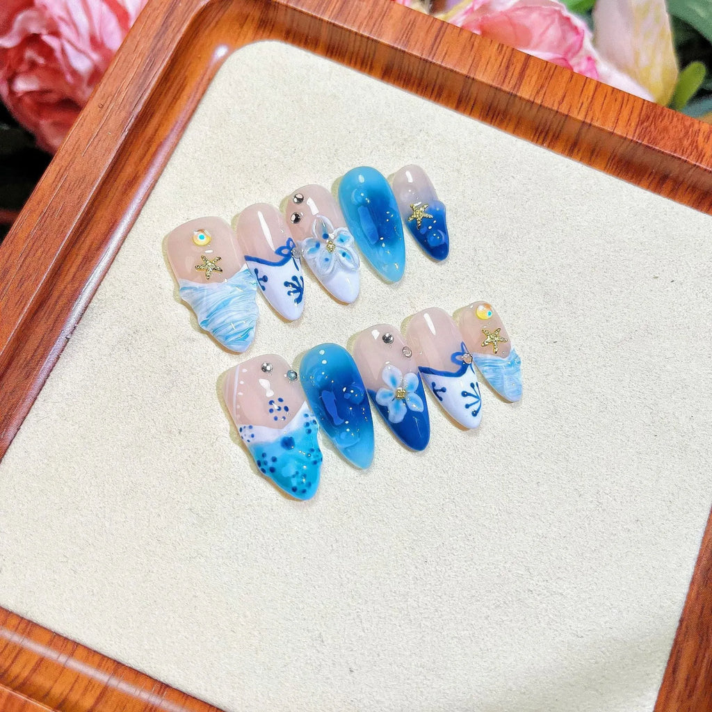 Blue hand-painted carved summer ice transparent plastic fake nails showing carved texture and transparent quality