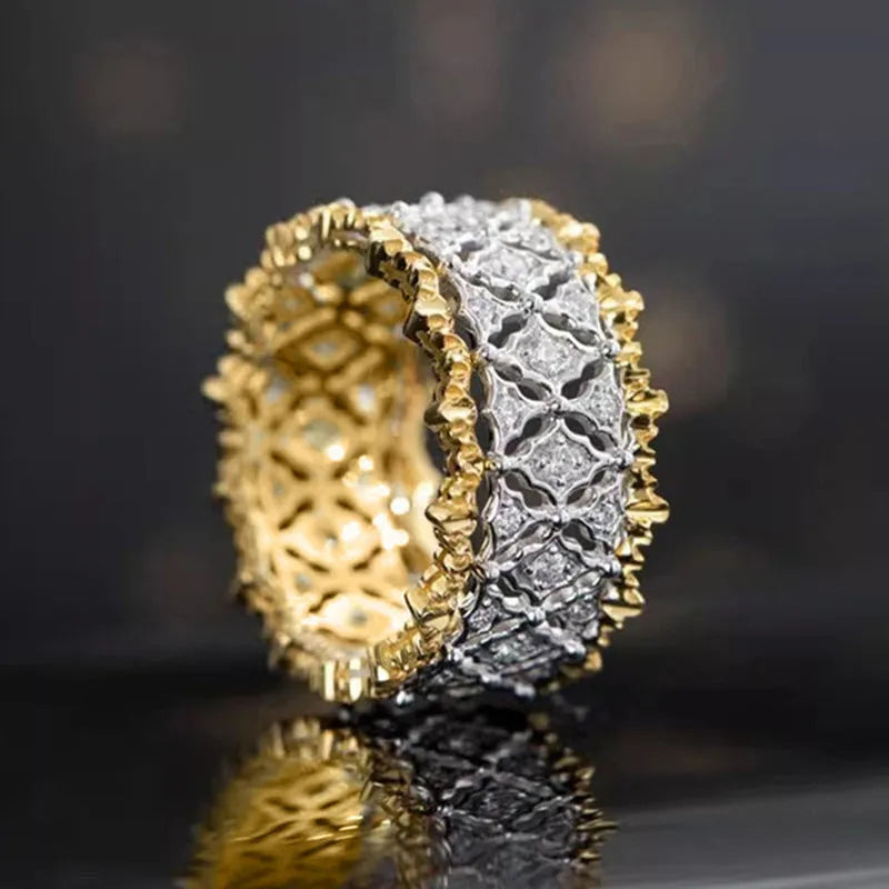 Geometric two-tone copper ring with a round zircon stone, shown in gold colour.