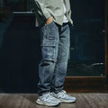 Blue men's loose straight-leg stretch jeans with a zip fly on a neutral background.