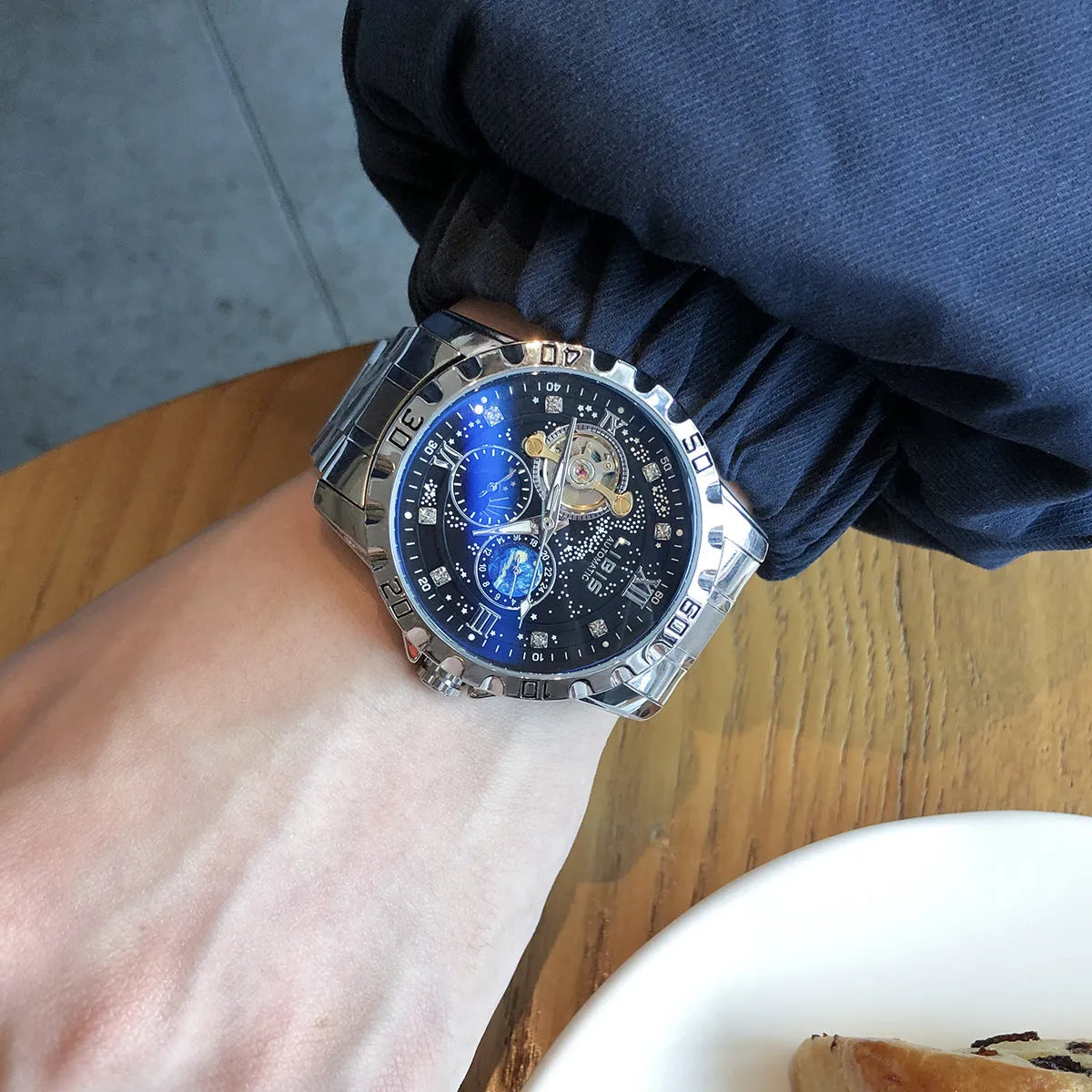 Men's silver automatic mechanical watch with black steel belt, 12mm case, and luminous starry dial
