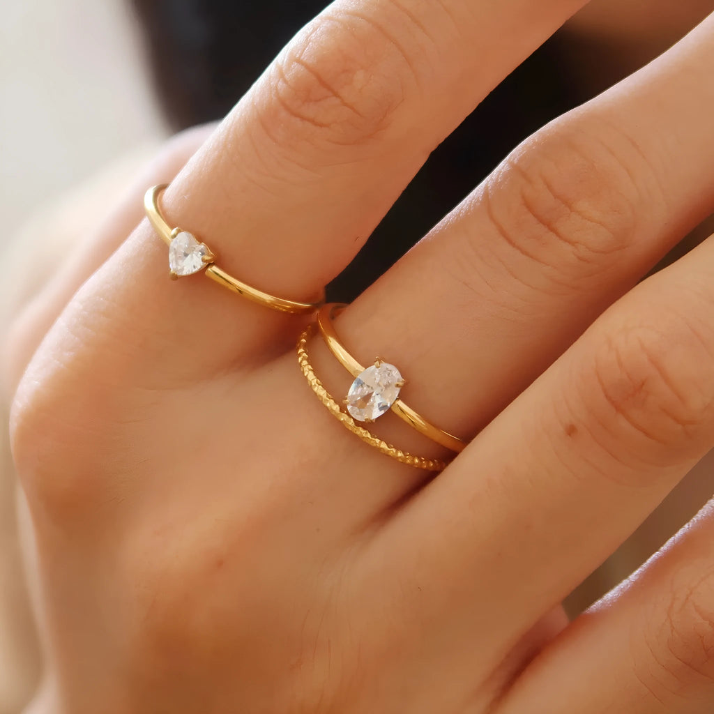 Golden love heart stainless steel ring on finger showing heart-shaped design element